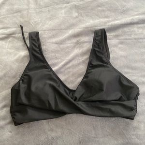 Size large black women’s bathing suit top with a tied back never worn
